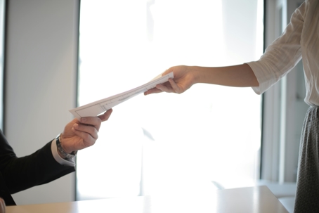 a women hands a man documents